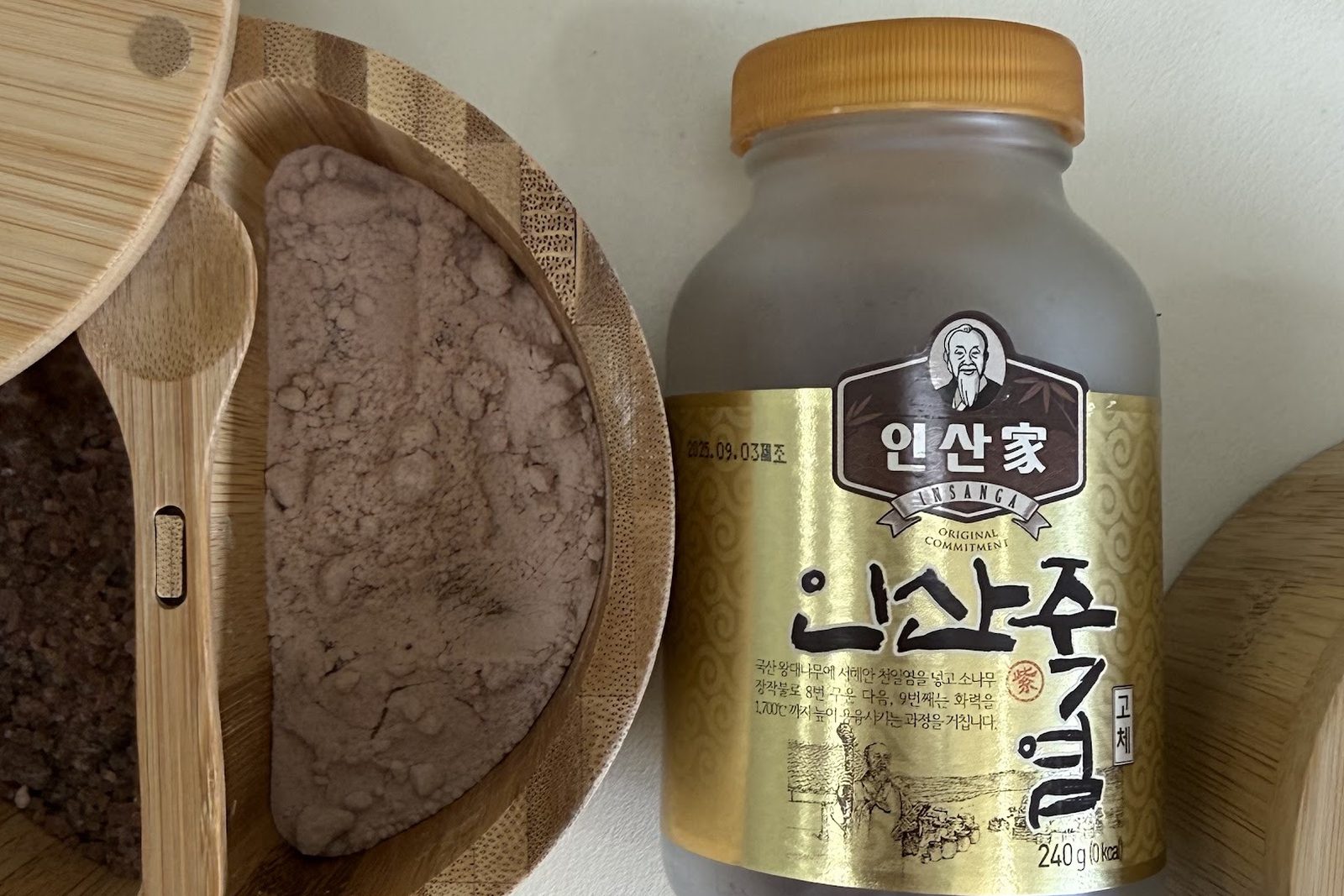 Bamboo salt in a wooden salt cellar beside an Insanga jar